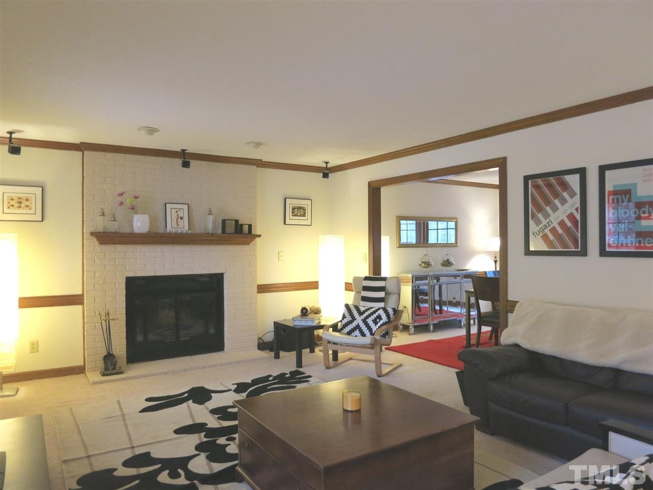 6408 Wynbrook Way Raleigh, NC 27612 - Photo 6 of 25 a living room with furniture and a fireplace