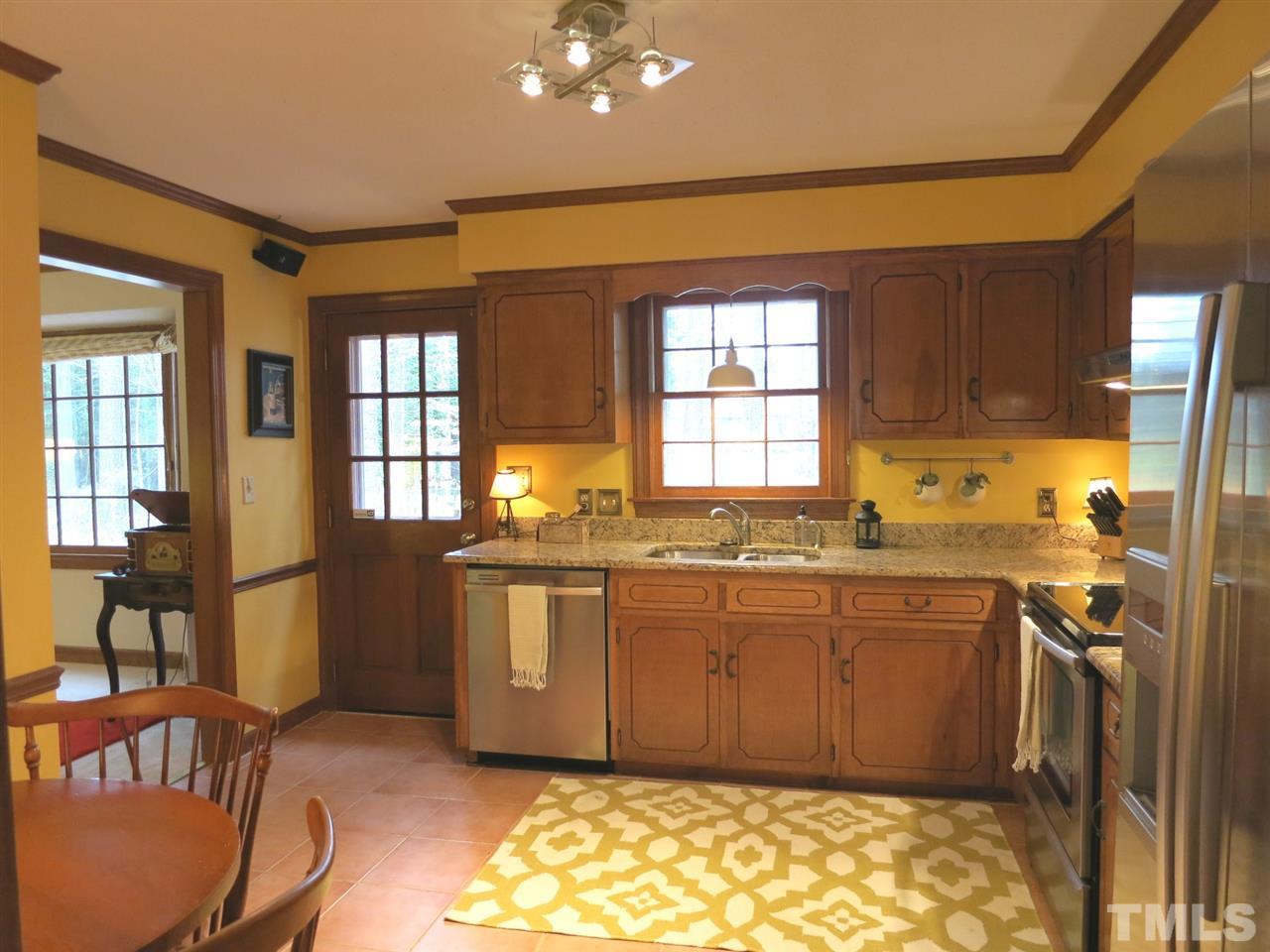 6408 Wynbrook Way Raleigh, NC 27612 - Photo 10 of 25 a kitchen with granite countertop sink cabinets and appliances