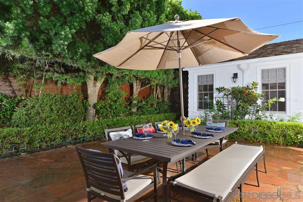 7865 El Paseo Grande La Jolla, CA 92037 - Photo 18 of 23 a view of a patio with furniture and table under an umbrella