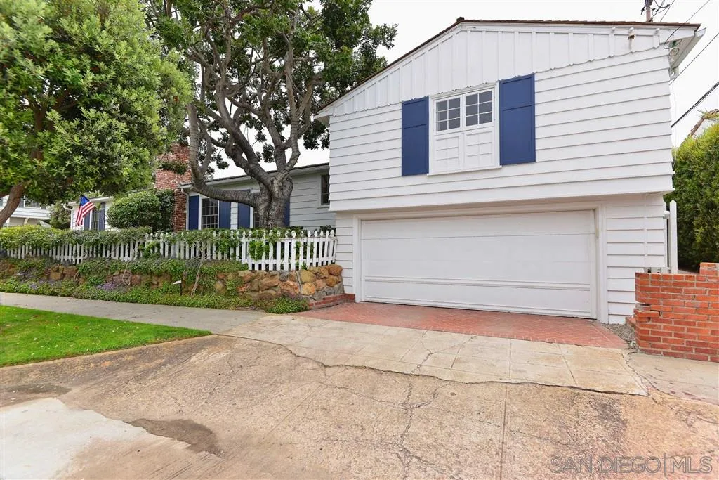 7865 El Paseo Grande La Jolla, CA 92037 - Photo 23 of 23 a front view of a house with a yard and garage