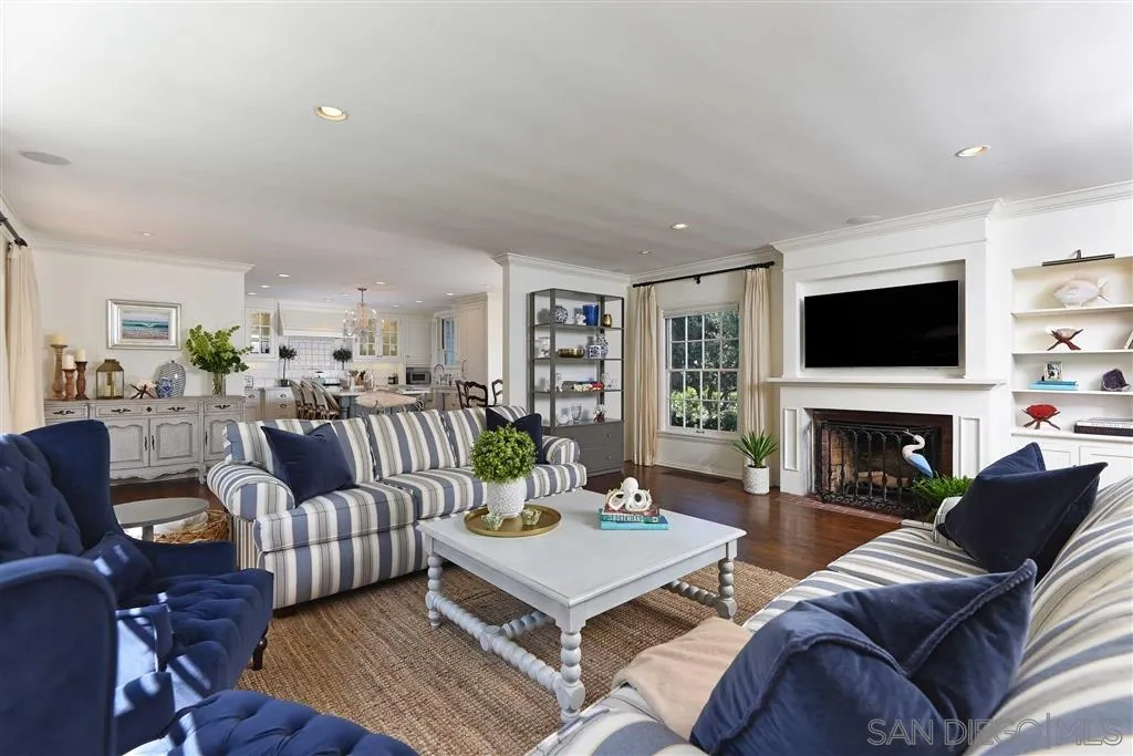 7865 El Paseo Grande La Jolla, CA 92037 - Photo 3 of 23 a living room with furniture a fireplace and a flat screen tv