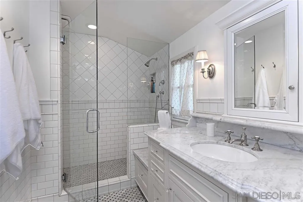 7865 El Paseo Grande La Jolla, CA 92037 - Photo 10 of 23 a bathroom with a granite countertop shower sink and mirror