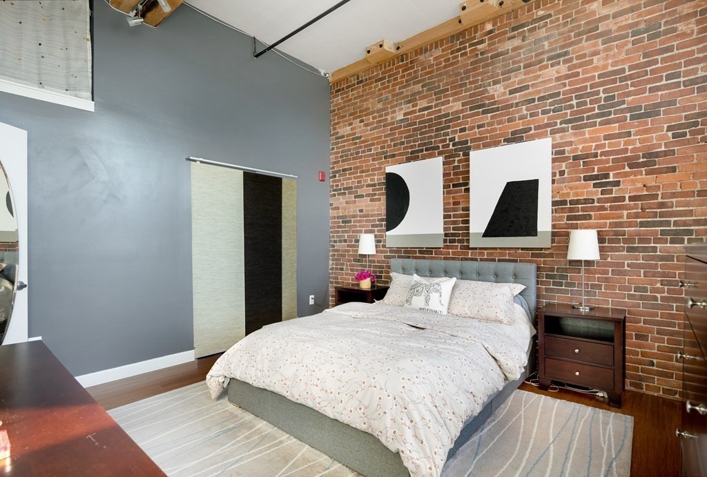 320 West 2nd Street, Unit 413 Boston, MA 02127 - Photo 13 of 20 a bedroom with a bed and wooden floor
