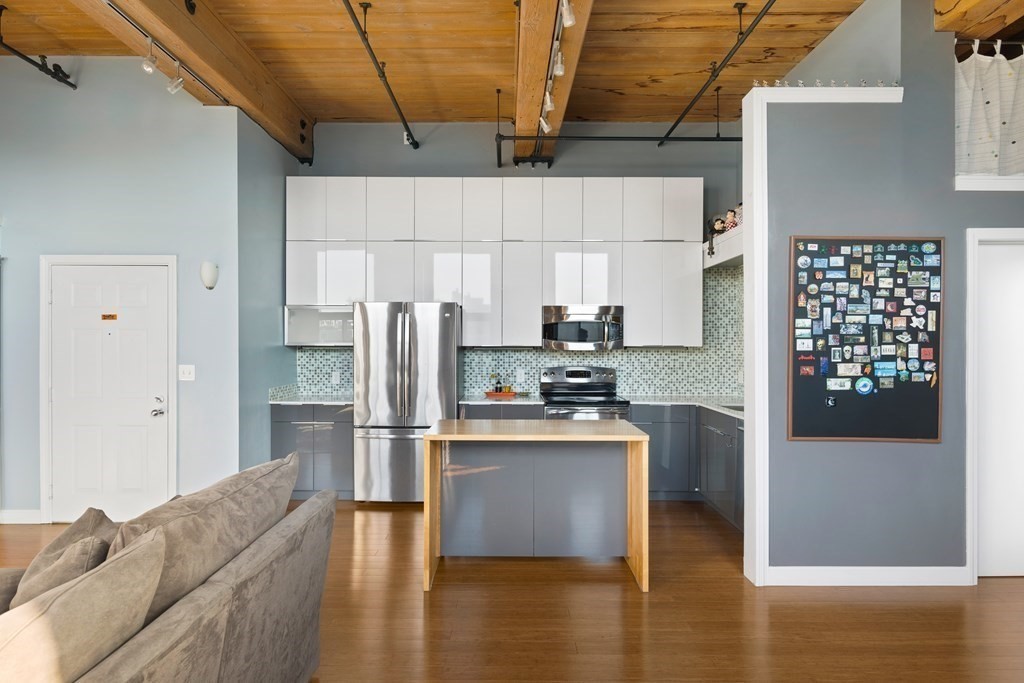 320 West 2nd Street, Unit 413 Boston, MA 02127 - Photo 4 of 20 a kitchen with stainless steel appliances a refrigerator and a stove