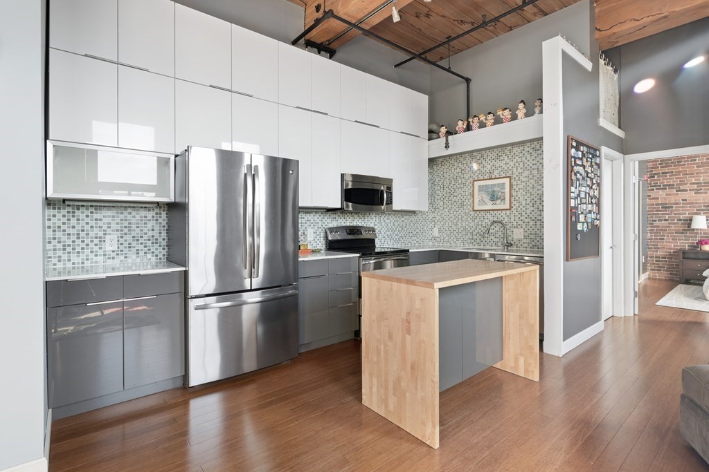 320 West 2nd Street, Unit 413 Boston, MA 02127 - Photo 6 of 20 a kitchen with stainless steel appliances granite countertop a refrigerator and a stove top oven