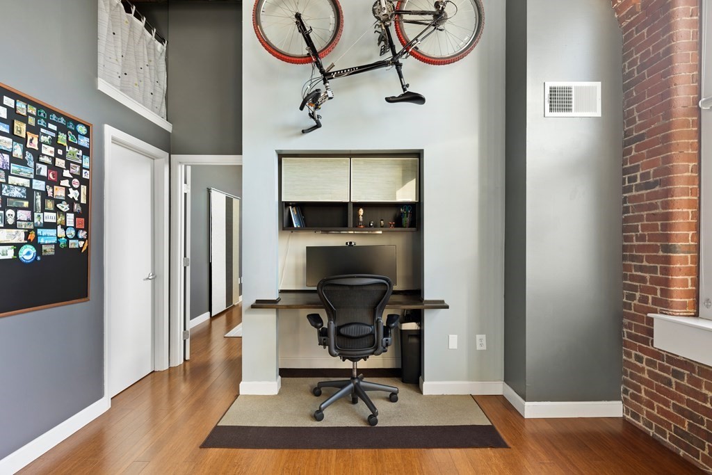 320 West 2nd Street, Unit 413 Boston, MA 02127 - Photo 8 of 20 a view of a workspace with furniture and wooden floor