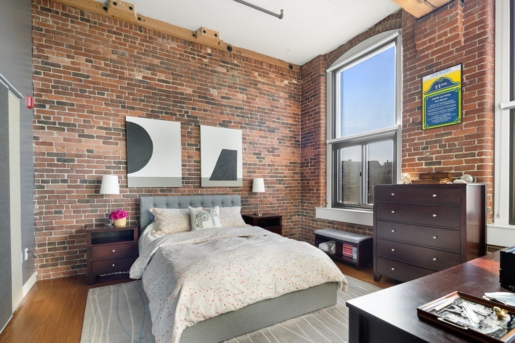 320 West 2nd Street, Unit 413 Boston, MA 02127 - Photo 9 of 20 a bed and a night stand in a bedroom