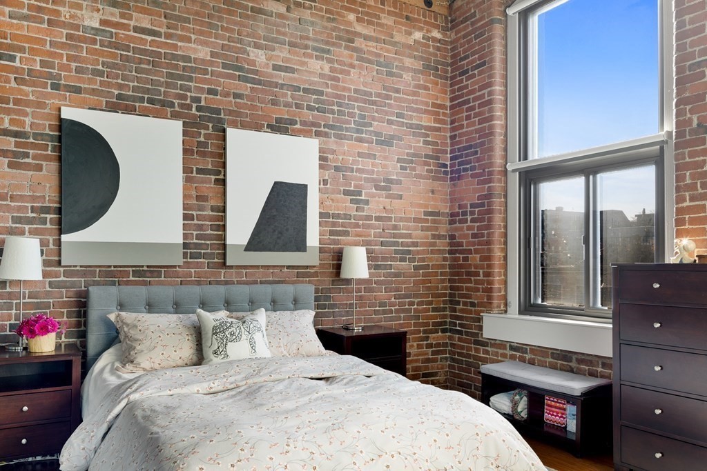 320 West 2nd Street, Unit 413 Boston, MA 02127 - Photo 10 of 20 a bedroom with a bed and a fireplace