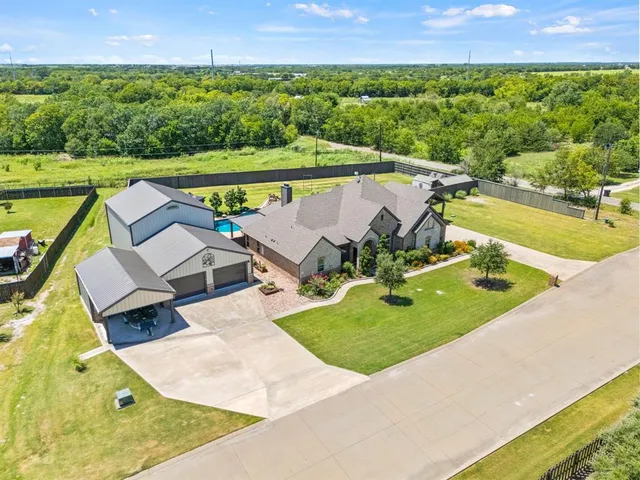 an aerial view of a house with a swimming pool