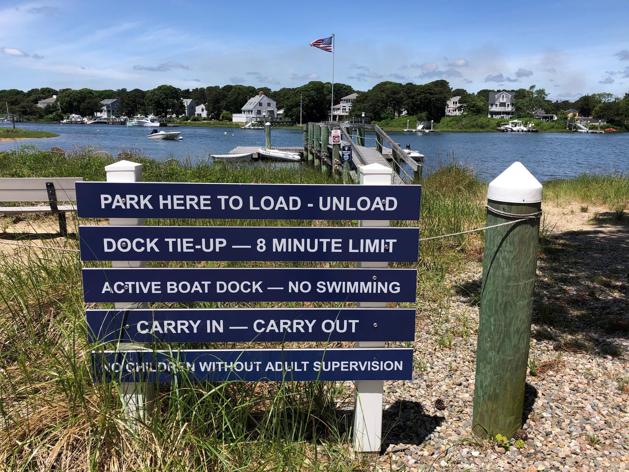 79 Neshobe Road Mashpee, MA 02649 - Photo 11 of 18 a sign on the side of the river