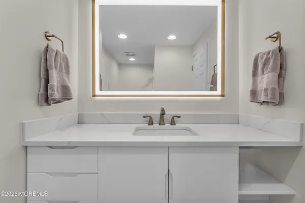 a bathroom with a sink and a mirror