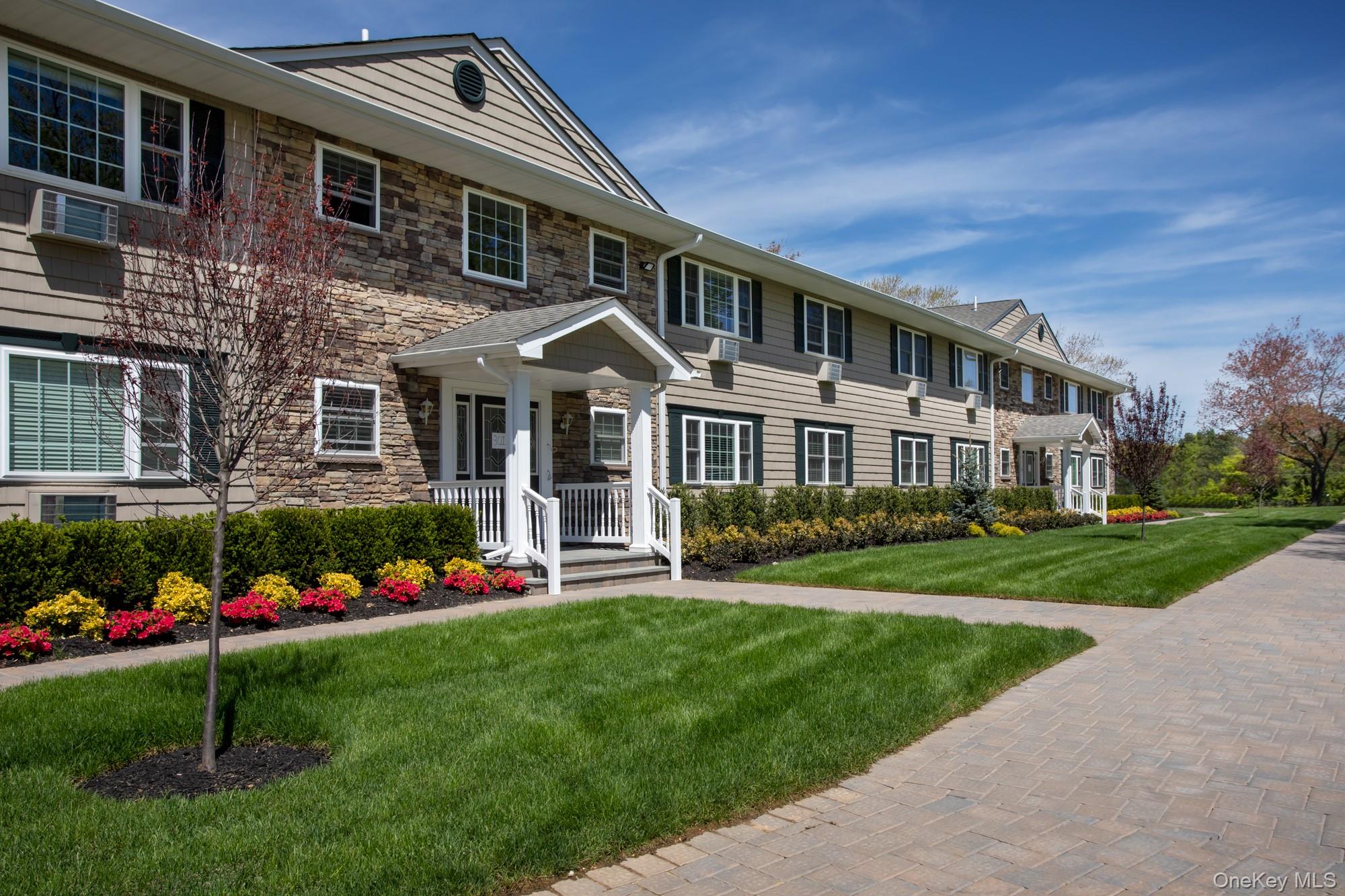 a front view of a house with a yard table and chairs