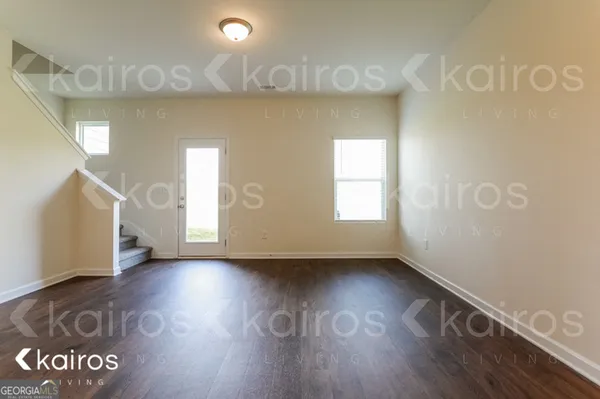 a view of an empty room and wooden floor