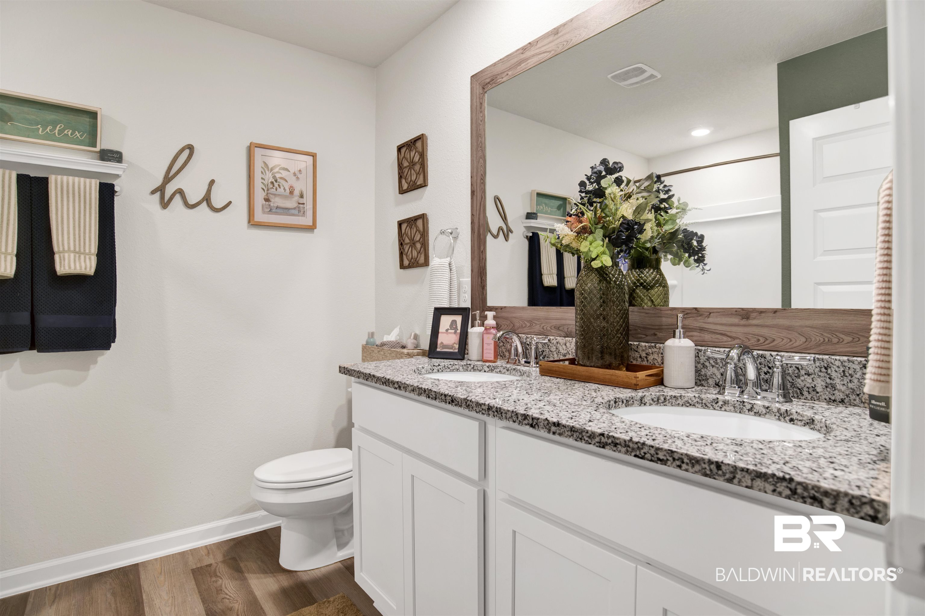 22301 Early Dawn Circle Foley, AL 36535 - Photo 11 of 45 Dual vanity featuring granite countertops, undermount sinks, and chrome faucets