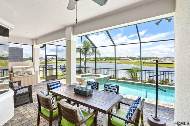 a view of a dining room with furniture large windows and wooden floor