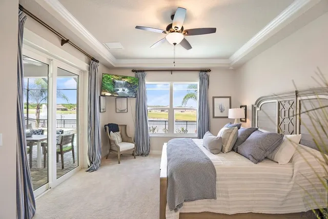 a bedroom with a large bed and a chandelier