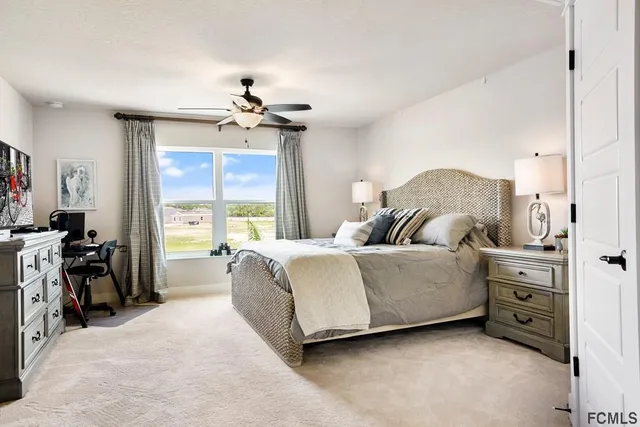 a bedroom with a bed dresser and a window