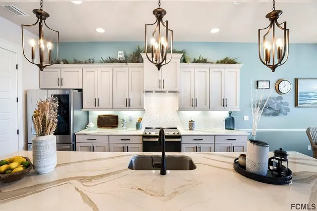 a kitchen with stainless steel appliances granite countertop a stove and refrigerator