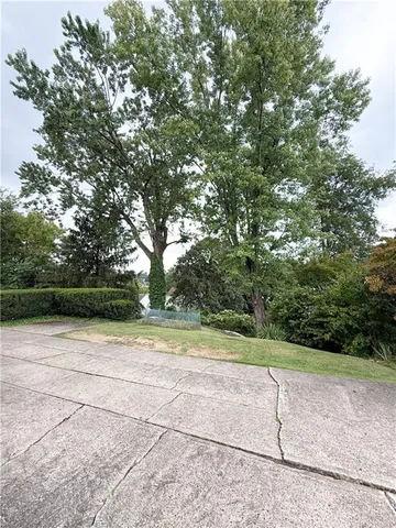 a view of backyard with outdoor seating and green space