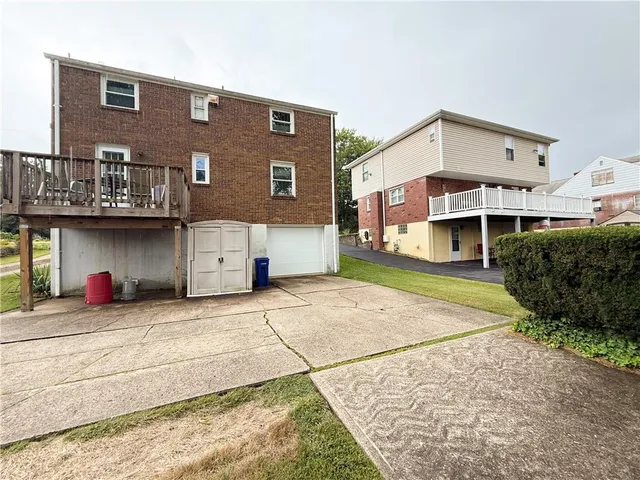 a view of a house with a patio and a yard