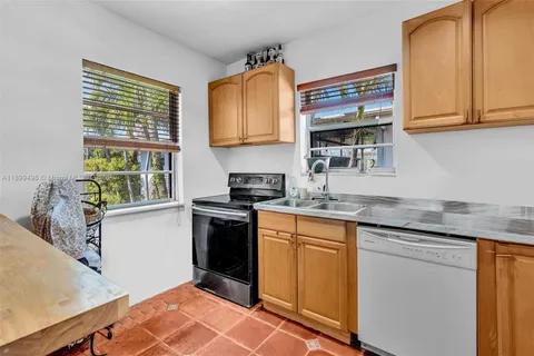 a view of a hallway with wooden floor and a living room