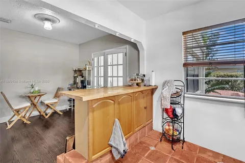 a bedroom with a bed and a wooden floor