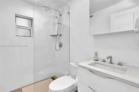 a backyard of a residential building with barbeque oven table and chairs