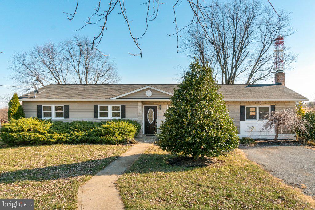 711 Ridge Road Mount Airy, MD 21771 - Photo 1 of 47 a front view of a house with a yard and garage