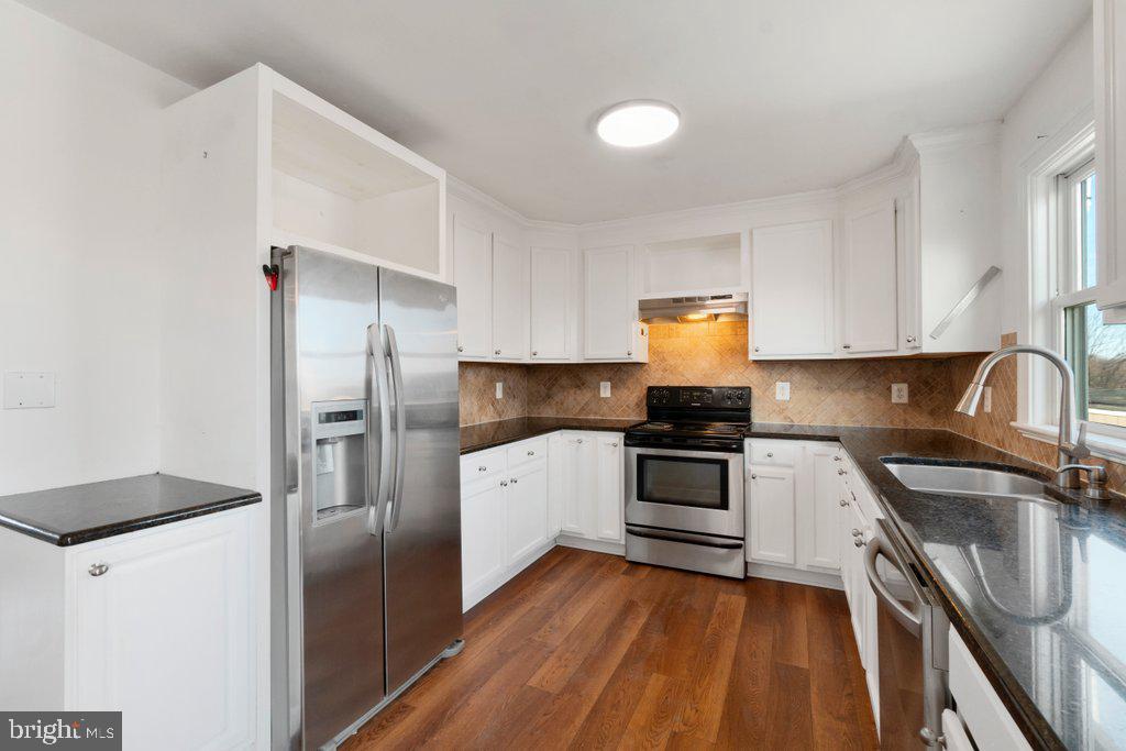 711 Ridge Road Mount Airy, MD 21771 - Photo 14 of 47 a kitchen with a refrigerator sink and wooden floor