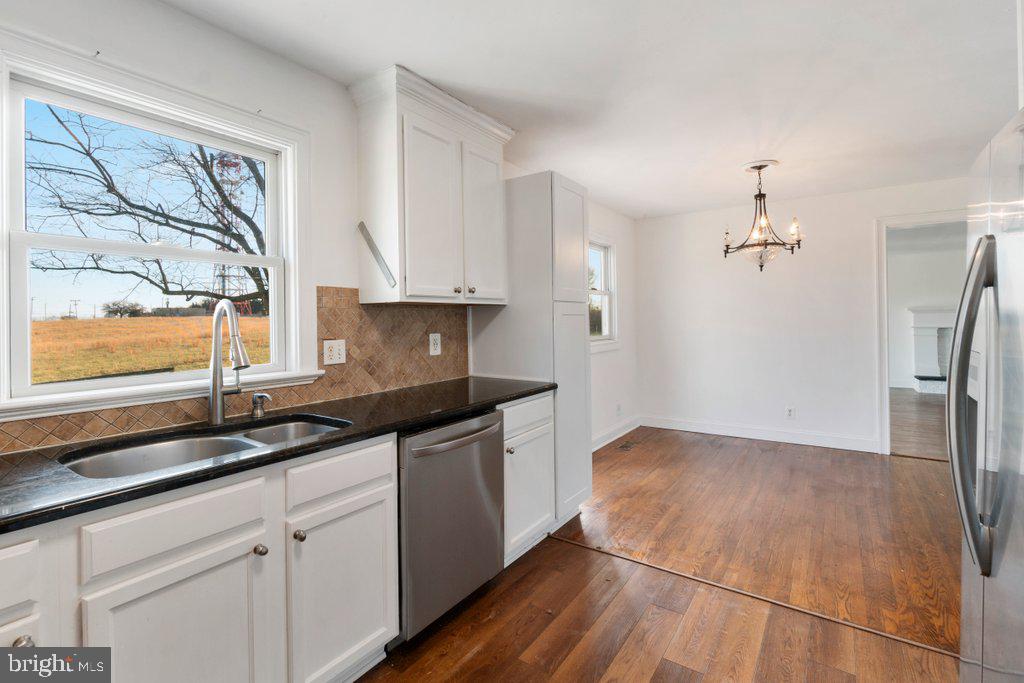 711 Ridge Road Mount Airy, MD 21771 - Photo 15 of 47 a kitchen with granite countertop a sink and a stove top oven