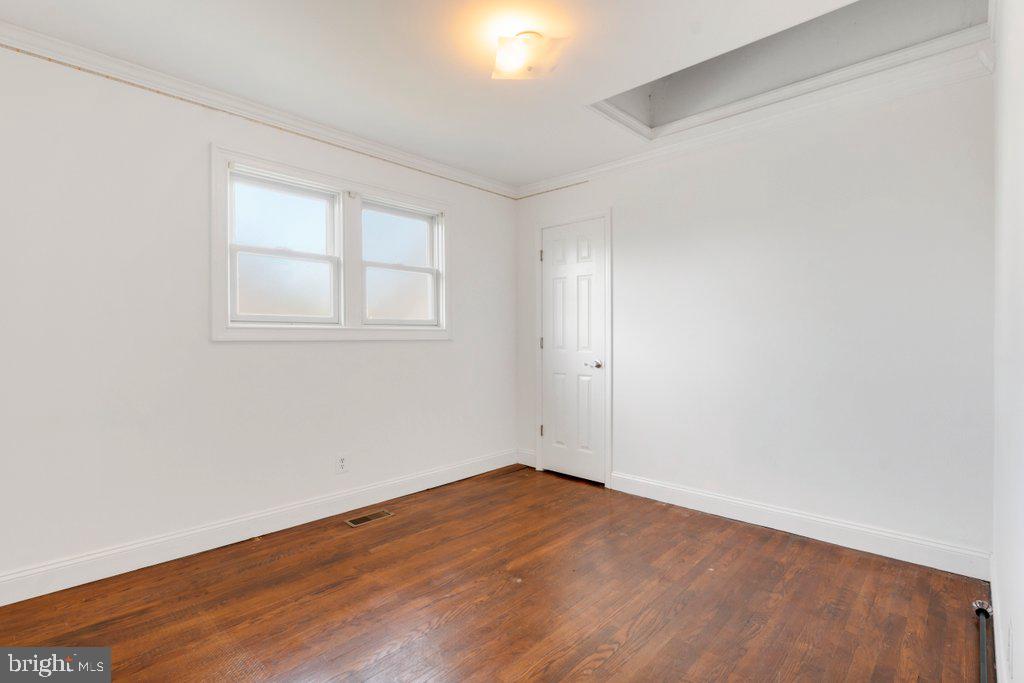 711 Ridge Road Mount Airy, MD 21771 - Photo 21 of 47 an empty room with wooden floor and windows