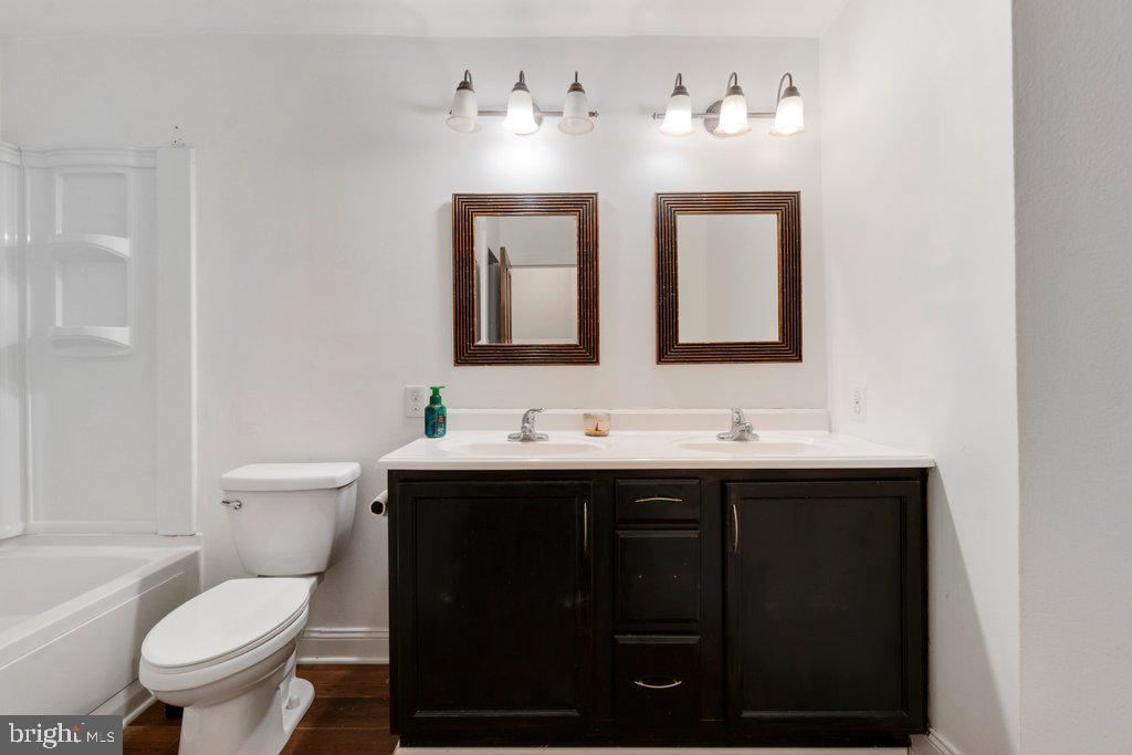 711 Ridge Road Mount Airy, MD 21771 - Photo 23 of 47 a bathroom with a toilet sink double vanity and mirror