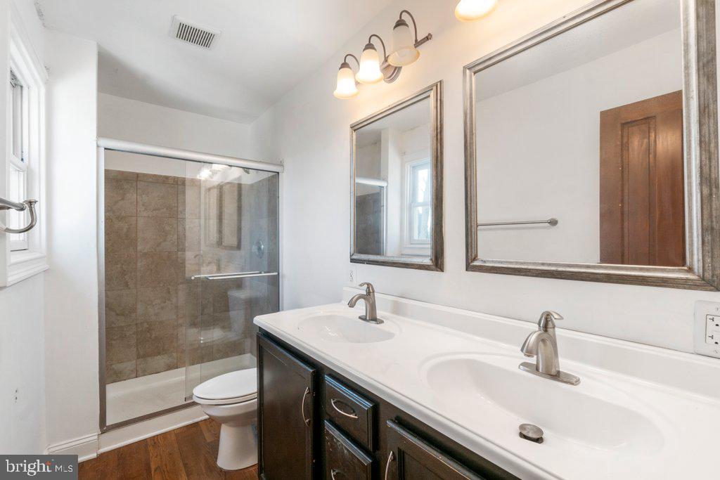 711 Ridge Road Mount Airy, MD 21771 - Photo 29 of 47 a bathroom with a sink toilet a mirror and shower