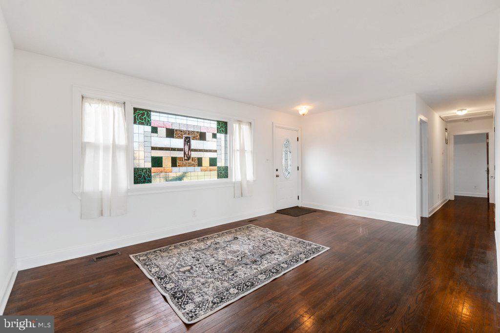 711 Ridge Road Mount Airy, MD 21771 - Photo 6 of 47 a view of an empty room with window and wooden floor