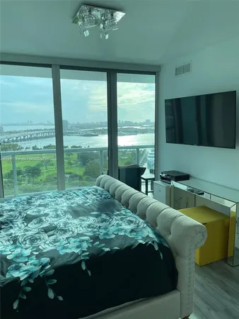 a living room with furniture and a floor to ceiling window