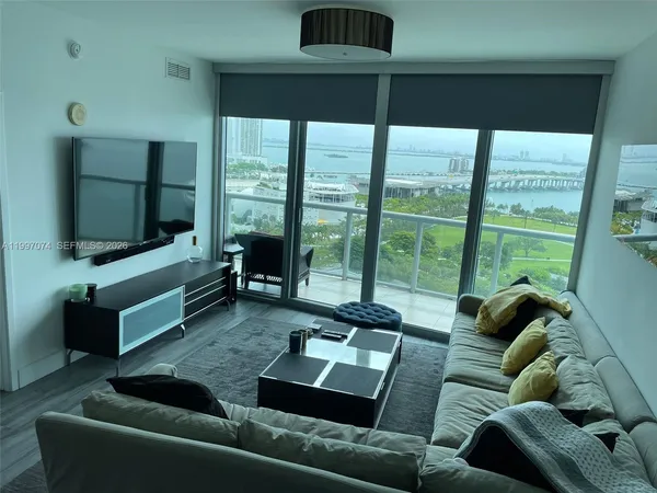 a living room with a flat screen tv and white walls