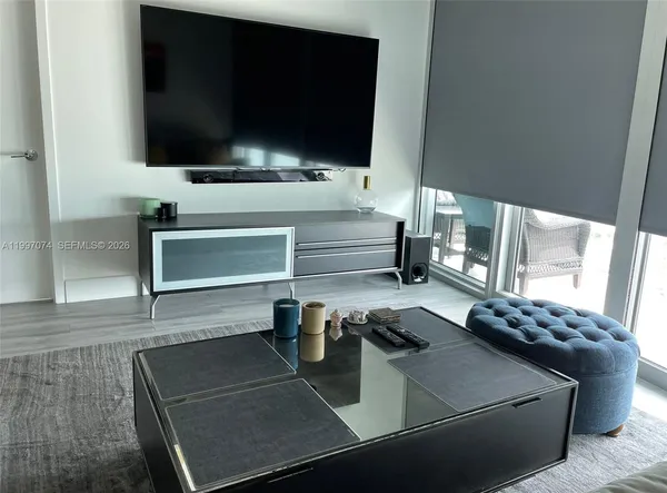 a living room with furniture and a large window