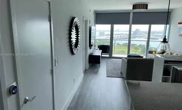 a kitchen with stainless steel appliances a sink cabinets and wooden floor