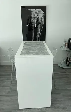 a living room with pool table and floor to ceiling window