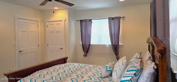 a bed sitting in a bedroom next to a window