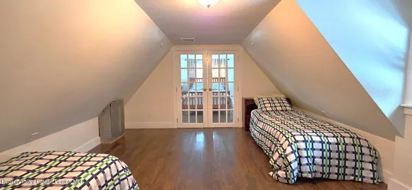 a view of wooden floor and windows in a room
