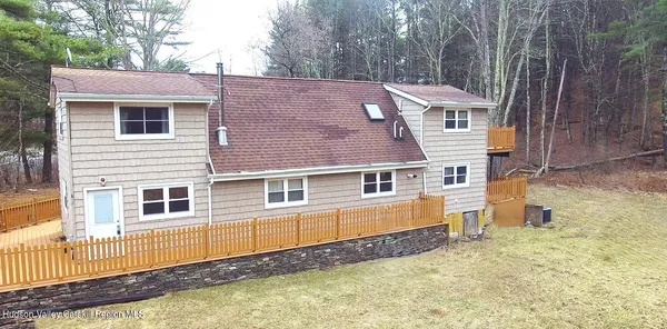 a living room with furniture and large windows