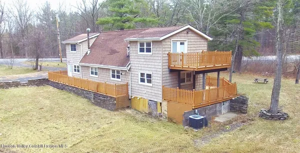 a kitchen with stainless steel appliances granite countertop a stove a refrigerator a sink a dining table and chairs with wooden floor