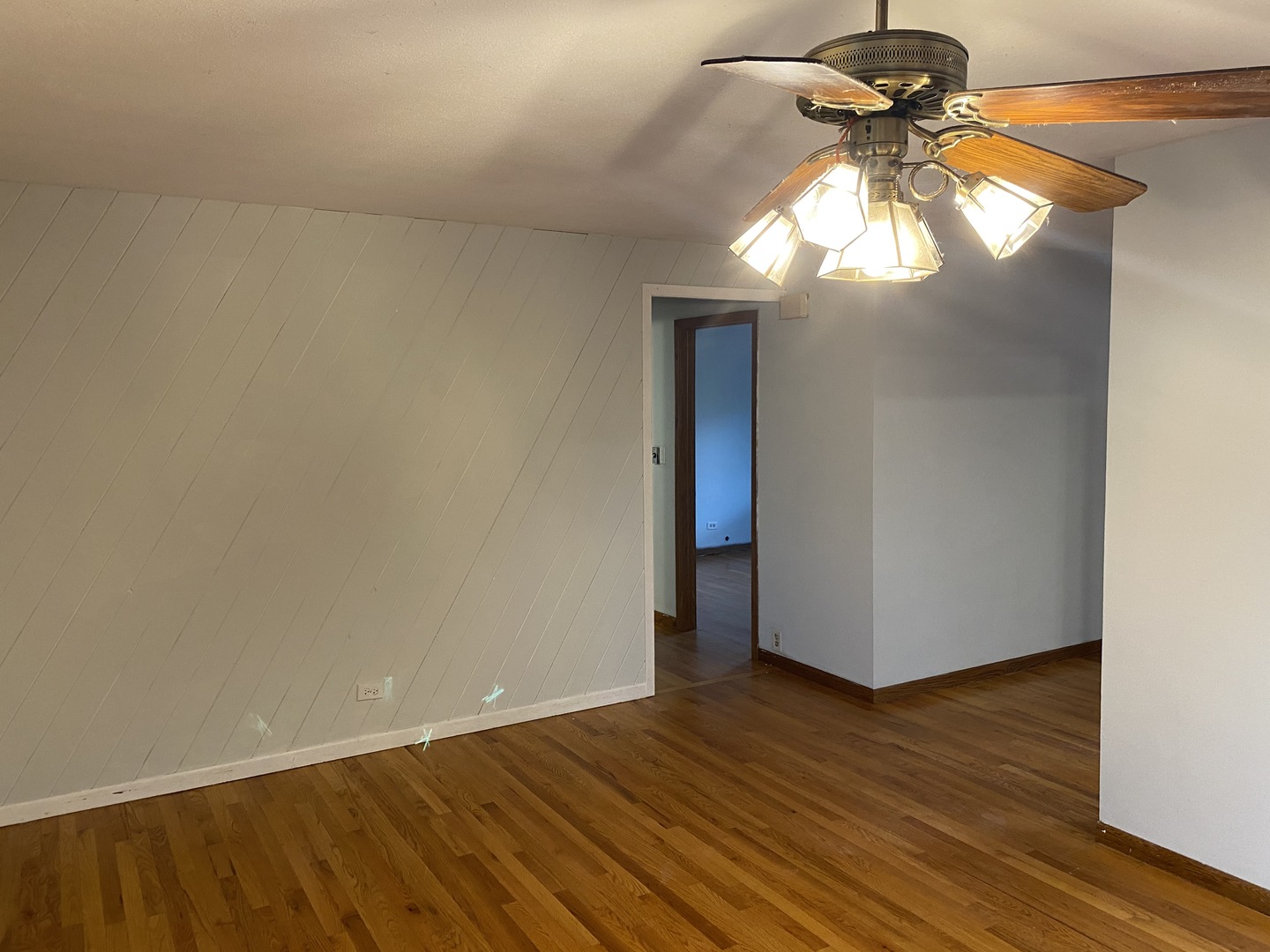 525 Northgate Road Lindenhurst, IL 60046 - Photo 5 of 10 a view of an empty room with wooden floor and a window