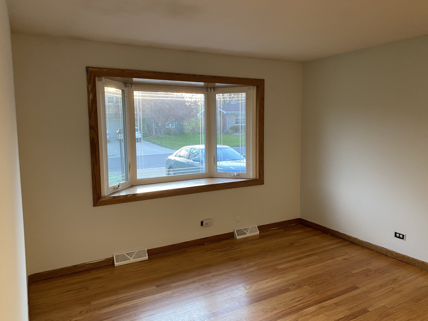 525 Northgate Road Lindenhurst, IL 60046 - Photo 9 of 10 a view of an empty room with wooden floor and a window