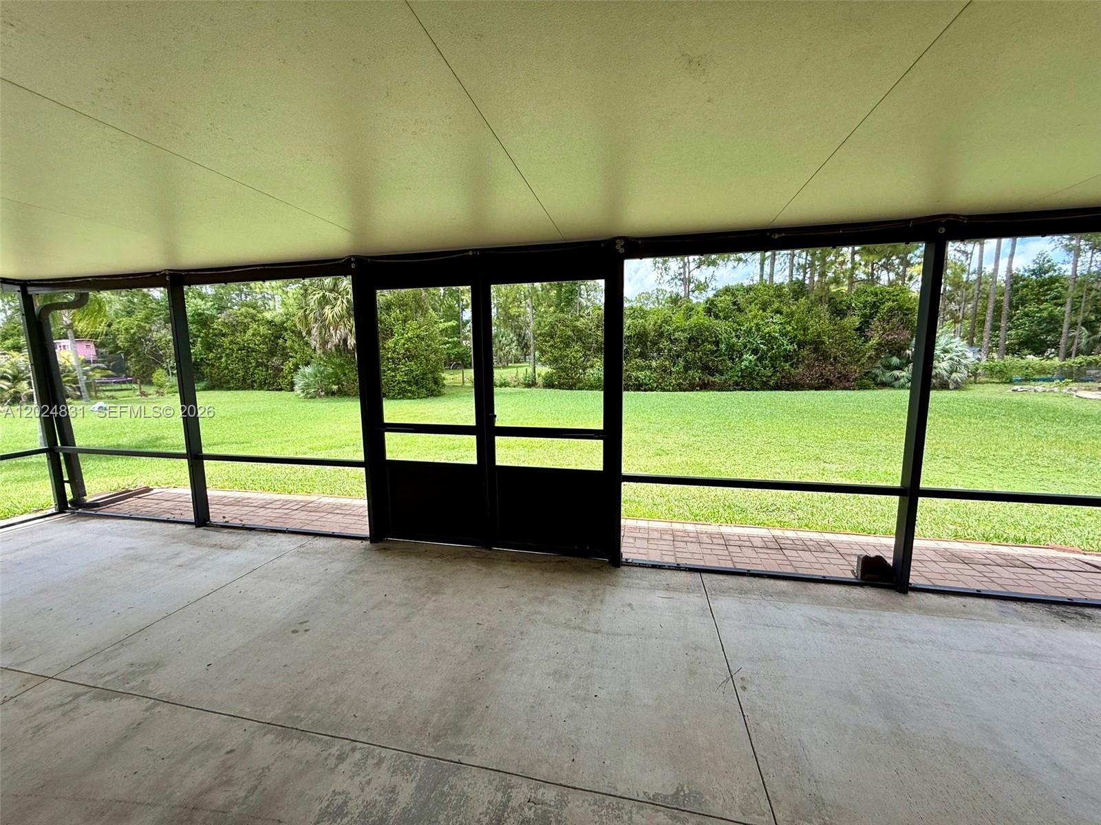15819 76th Road North Loxahatchee, FL 33470 - Photo 22 of 45 an empty room with wooden floor and windows