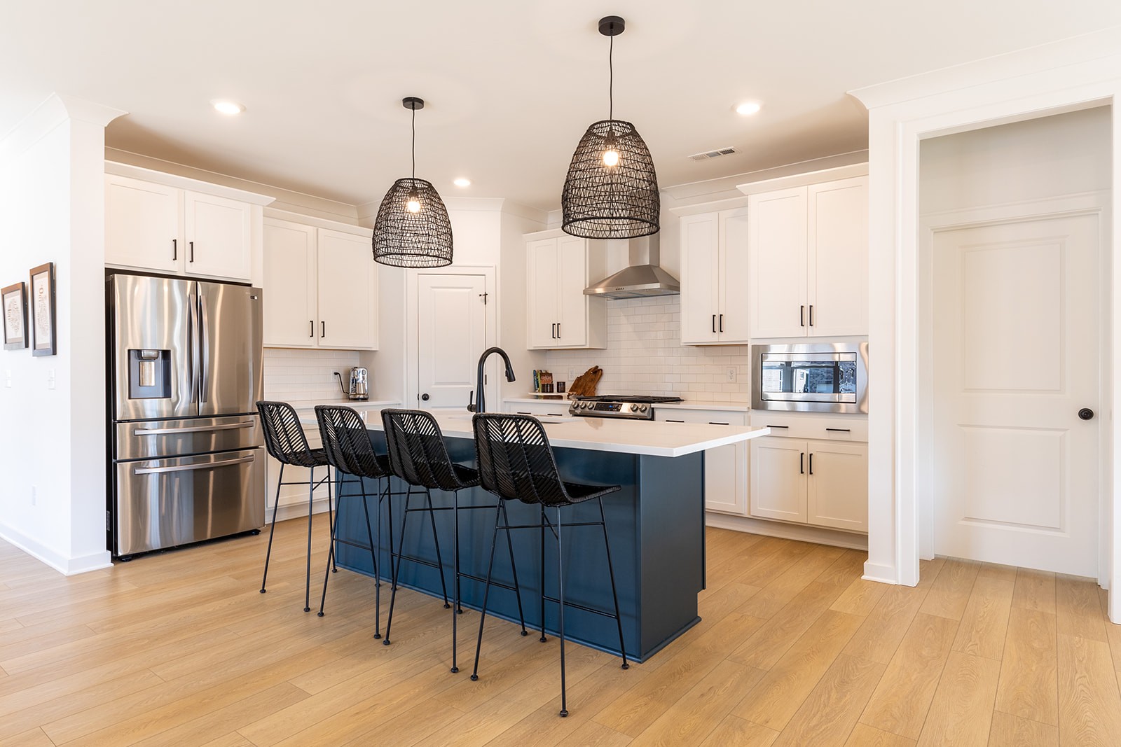 2000 Farm Street Mount Juliet, TN 37122 - Photo 6 of 34 a kitchen with stainless steel appliances granite countertop a sink dishwasher a refrigerator cabinets and a dining table with wooden floor