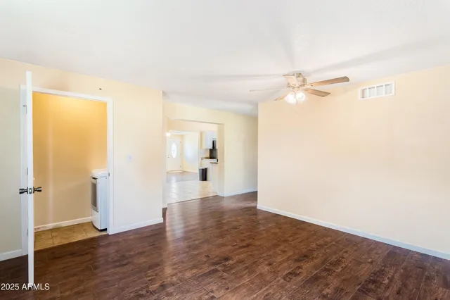 a view of a room with wooden floor closet and windows