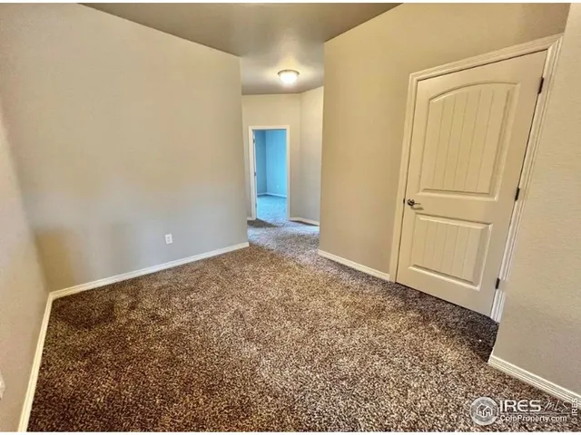 a view of a room with an empty space and wooden floor