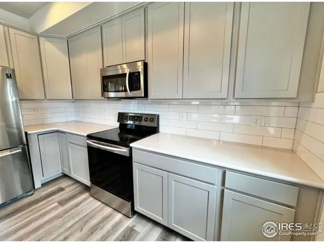 a kitchen with a sink and a stove top oven